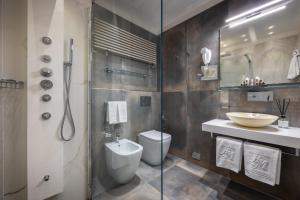 a bathroom with a toilet and a sink and a shower at Hotel Metropole in Santa Margherita Ligure