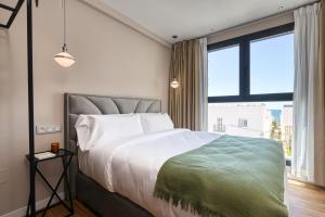 Postel nebo postele na pokoji v ubytování Palm Suites