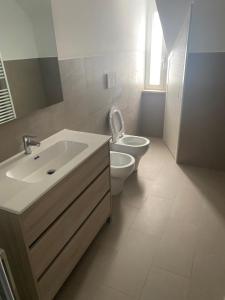 a bathroom with a sink and a toilet and a mirror at Camera Quadrupla 3 Civitanova Marche in Civitanova Marche
