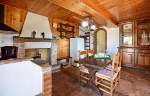 a kitchen with a table and a fireplace at Casa La Borra in Camaiore
