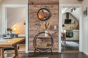a dining room with a table and a mirror on a wall at Hirsch-Apartment-5 Eulennest in Bad Harzburg +27 photos