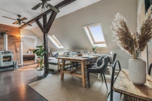 a dining room with a table and a living room at Hirsch-Apartment-5 Eulennest in Bad Harzburg