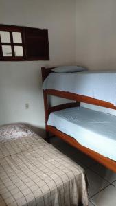 a bedroom with two bunk beds and a bed at Hostel Vitória Régia in São Luís