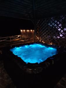 a large swimming pool at night with lights at KERAME PARADISE VILLA in Agios Kirykos