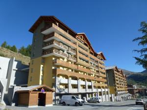 a large building with cars parked in front of it at Appartement de 3 pièces au centre d'Isola 2000, parking, proche pistes - FR-1-292-210 in Isola