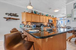 a kitchen with a large island with a counter top at Dottie's Sandbar in Navarre