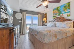 a bedroom with a bed with a ceiling fan at Dottie's Sandbar in Navarre