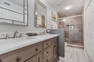 a bathroom with a sink and a shower at Dottie's Sandbar in Navarre