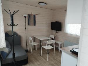 a small dining room with a table and chairs at Domek "Marla 1" in Żelistrzewo