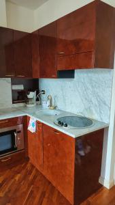 a kitchen with a sink and a microwave at Scarlet Flower - Lago Maggiore in Meina +45 photos