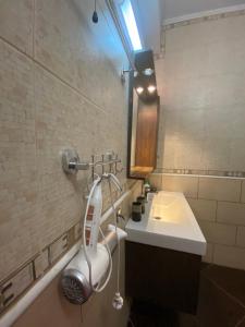 a bathroom with a hairdryer on the wall next to a sink at Villa Vision in Skala Potamias +76 photos