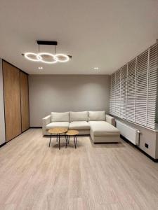 a living room with a couch and a table at Oostendelle in Ostend