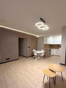 a room with a table and chairs and a kitchen at Oostendelle in Ostend