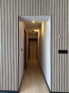 an empty hallway with a door and a hallwayngthngthngthngthngthngthngth at Oostendelle in Ostend +1 photo