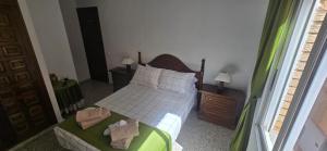 a bedroom with a bed with two towels on it at Casa de la Felicidad cerca de la playa in Santa Pola +22 photos