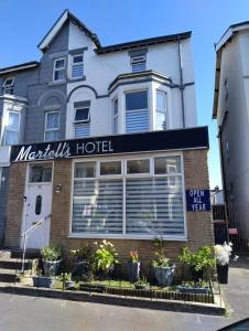 a magnitzias hotel on the side of a building at Martell's Hotel in Blackpool