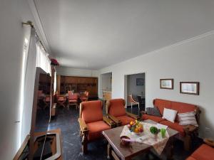 un soggiorno con un divano, sedie e un tavolo di Penthouse Anneliese ad Atene