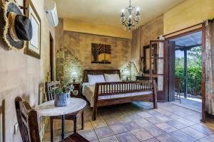 a bedroom with a bed and a table at Yianna Sunny Studios in Skopelos Town