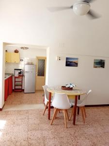 a kitchen and dining room with a table and chairs at Belvedere in Pantelleria +22 photos
