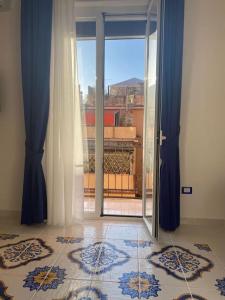 an open glass door with a view of a balcony at Mery Blue tra Pompei e Sorrento in Castellammare di Stabia