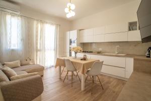 a kitchen and living room with a table and chairs at La Casa di Girolamo e Irene in Lampedusa