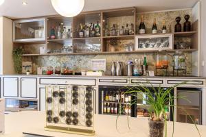 a bar with lots of bottles on the wall at Best Western Les Bains Hotel et SPA in Perros-Guirec
