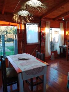 a table and chairs in a room with a table at FINCA los nogales in General Belgrano
