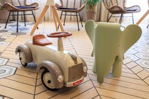 a toy car and an elephant sitting on a floor at Best Western Les Bains Hotel et SPA in Perros-Guirec