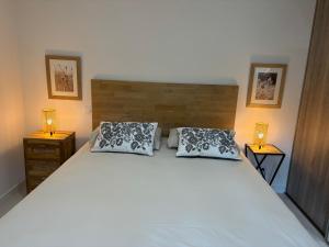 a bedroom with a large white bed with two pillows at Villa Casa Sole e Mare in Conca