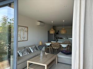 a living room with a couch and a table at Villa Casa Sole e Mare in Conca