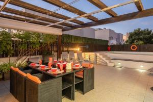 an outdoor patio with a table and chairs at Vila Cantinho Algarvio Vista Rio in Ferragudo