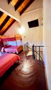 a bedroom with two beds in a room at Apart Hotel Géminis in Termas del Daymán
