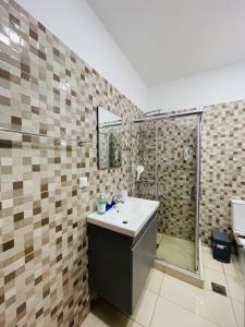 a bathroom with a sink and a shower at Lafo Rooms in Elafonisi