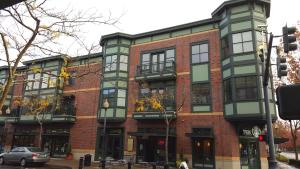 a brick building on a street with a car in front at Orenco Lofts in Hillsboro