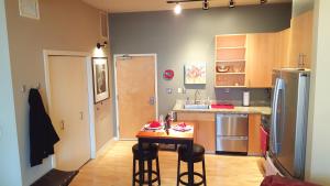 a small kitchen with a table and chairs in it at Orenco Lofts in Hillsboro