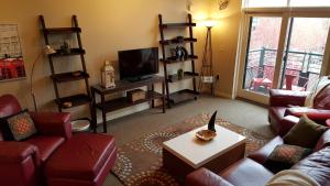 a living room with red couches and a tv at Orenco Lofts in Hillsboro +14 photos