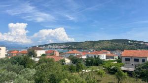 a town with houses and a mountain in the background at Astralis in Trogir