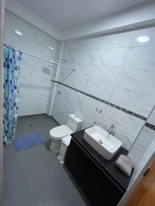 a bathroom with a sink and a toilet at Ravenala - Apartment Paracas in Paracas +22 photos