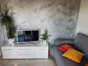 a living room with a tv on a white cabinet at Astralis in Trogir