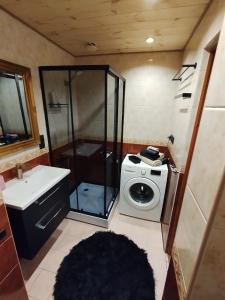 a bathroom with a shower and a washing machine at Kitse 26 Apartment , Self Check-in, Free Parking in Pärnu +19 photos