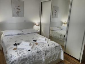 a bedroom with a bed and two mirrors at Astralis in Trogir