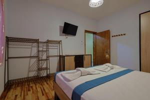 a bedroom with a bed with a tv on the wall at Zeusplace Alexandra's Pool Villa Katerini in Katerini +52 photos