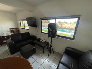 a living room with a television and a couch at Village Berries Alpuyeca in Alpuyeca