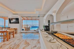 a kitchen with a counter with food on it at Naxos Grand Hotel in Agios Prokopios