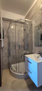 a bathroom with a shower and a sink at Karmelowy Zakątek in Darłowo +40 photos