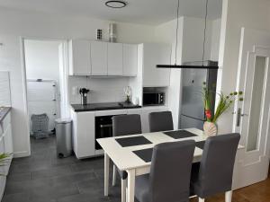 a kitchen with a table and chairs in a kitchen at Charming apartment close to Paris and airports in Antony