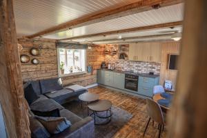a living room with a couch and a kitchen at Rostad Retro Rorbuer in Reine