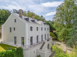 a large white house with a brick wall at 3 - Grand Appartement dans Château & Domaine privé à 15min de Lyon in Vourles