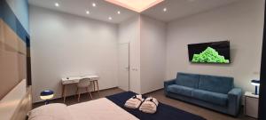 a bedroom with a bed and a blue couch at La Maison sul Porto in Anzio