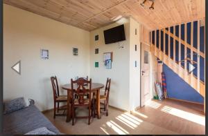 a dining room with a table and chairs and a tv at SoCloseBeach Apartament Chłopy in Chłopy